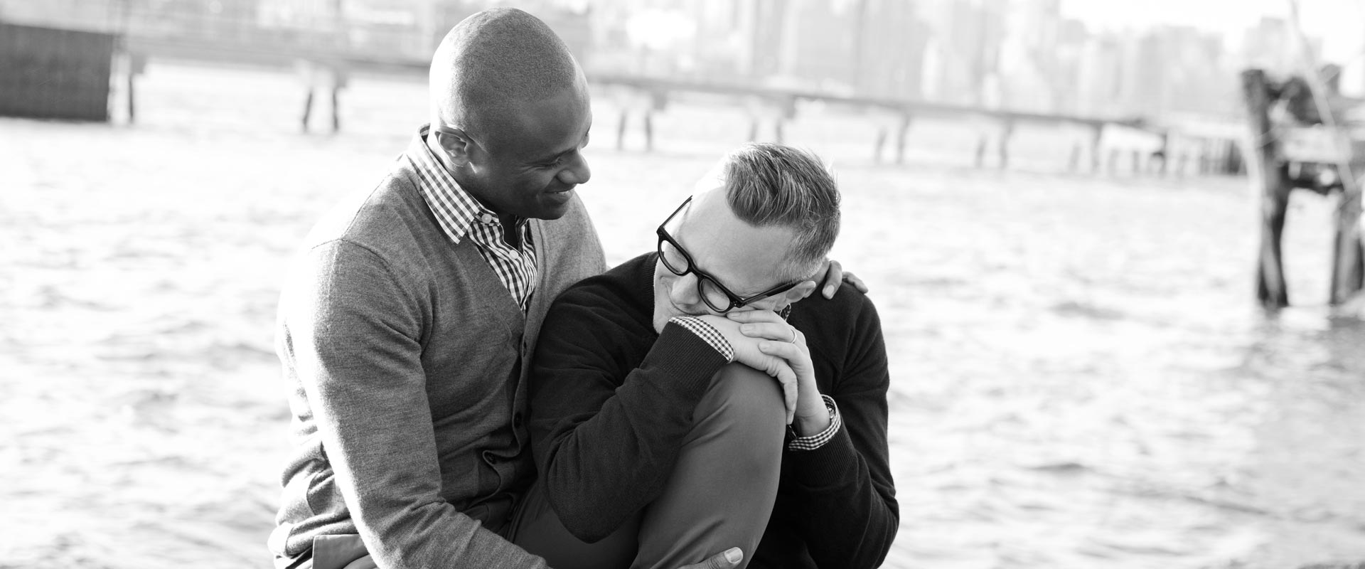 Gay couple showing love by hug each other in font of the sea